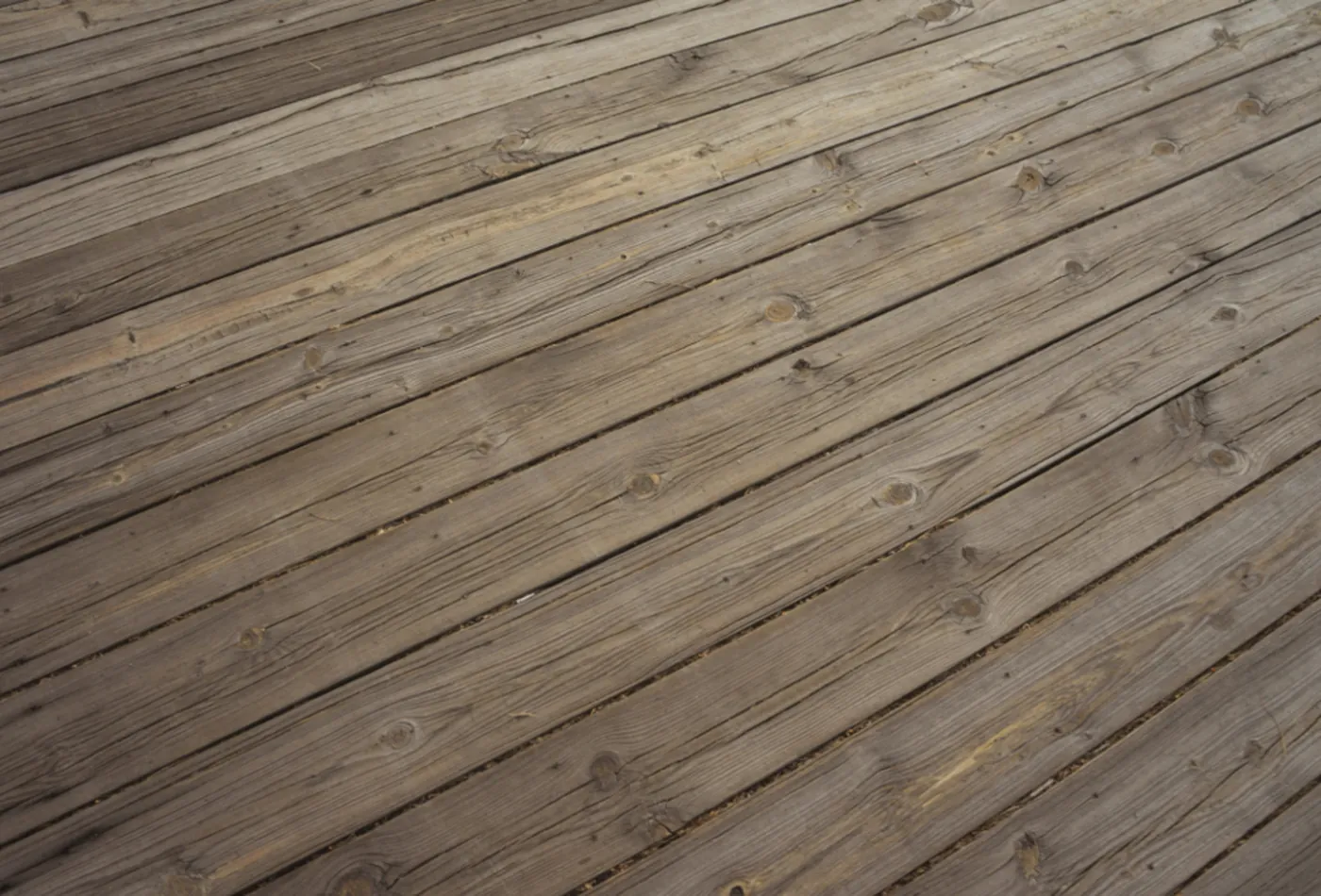Clean pressure-treated deck boards laid on a diagonal